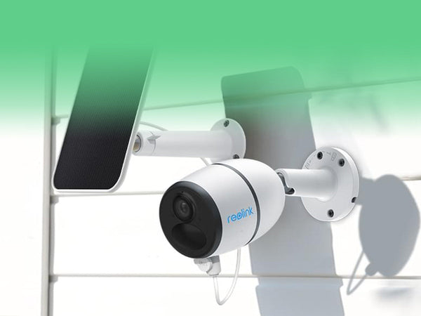 A white Reolink security camera with a solar panel mounted on an outdoor wall.