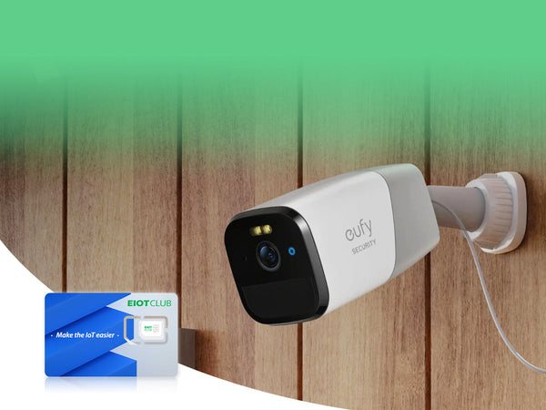 A Eufy security camera mounted on a wooden wall, with an EIOTCLUB SIM card.