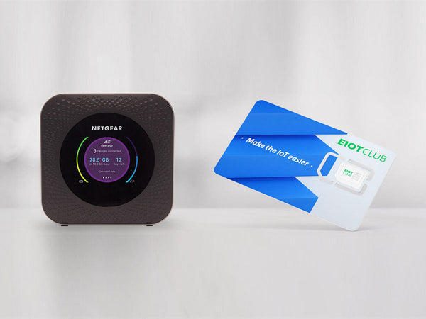 A Netgear mobile hotspot device displayed next to an EIOTCLUB SIM card on a white surface.